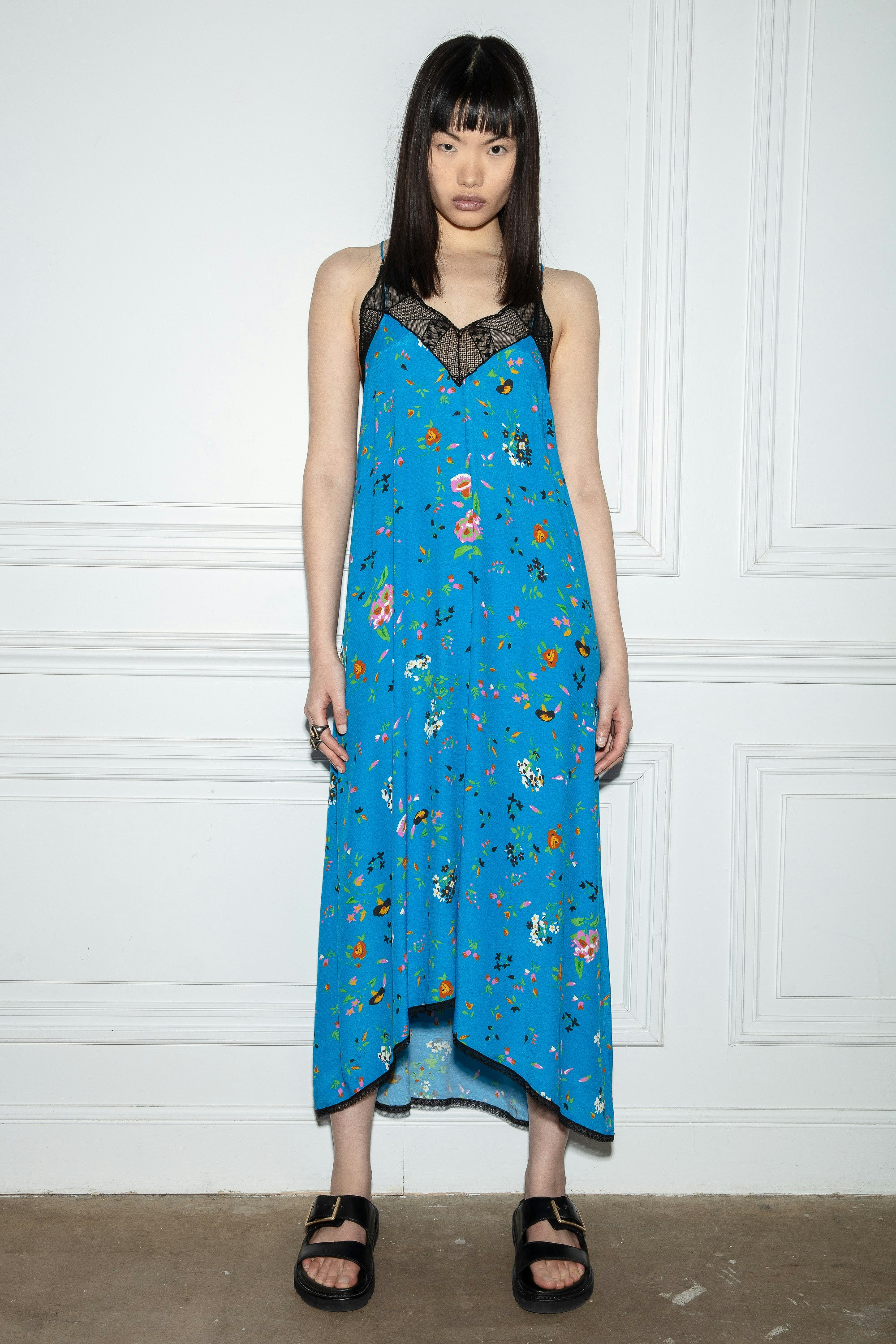 Risty Dress Women’s long blue flowing dress with thin straps, embellished with a floral print and contrasting lace edges