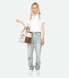 Mirta Polo - Short-sleeved cropped polo with embroidered wings on the front.