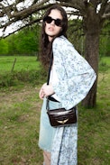 Le Zazi Vintage Patent Bag - Small vintage-inspired patent leather bag with adjustable shoulder strap and signature wings.