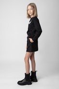 Alice Girls’ Skirt - Girls’ black cotton fleece skirt with diamanté and wings motif on the back.