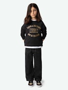 Sweatshirt Upper Fille - Sweatshirt molletonné en coton biologique noir à manches longues et broderie métallisée blason fille.