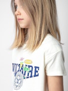 T-shirt Anja Fille - T-shirt fille à manches courtes en jersey coton écru orné d'illustration.