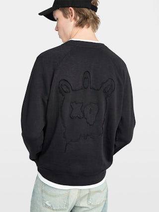 Uppy Sweatshirt - Long-sleeve raglan sweatshirt with embroidered patch on the back.