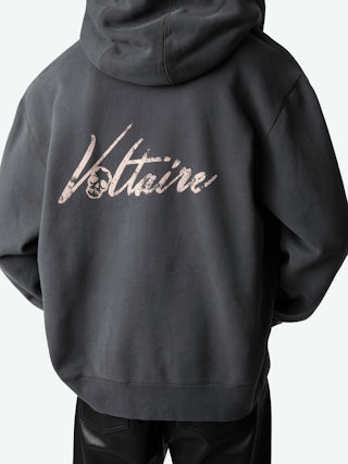 Sacha Sweatshirt - Grey zipped fleece sweatshirt with hood, long sleeves, and "Voltaire" print on the back.