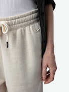 Pantaloni da Jogging Sofia - Pantaloni da jogging beige con coulisse e ali ricamate sul davanti.