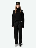 Pantaloni da Jogging Chill - Pantaloni neri da jogging dritti e ampi, tasche con cerniera a contrasto e ricamo con ali distintive.