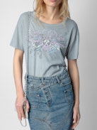 T-shirt Marta Concert Strass - T-shirt grigia a maniche corte con motivi Concert, teschio e ali in strass.