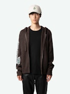 Oliver Cardigan - Long-sleeved brown knitted zip-up cardigan with hood, Dinosaur intarsia motif on back and "Art Is Truth" message on right sleeve.