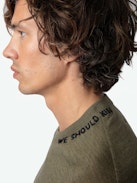 Marko Jumper 100% Merino Wool - Long-sleeved loose-fitting khaki 100% merino wool jumper with ‘We Should Kiss’ embroidery on the collar.