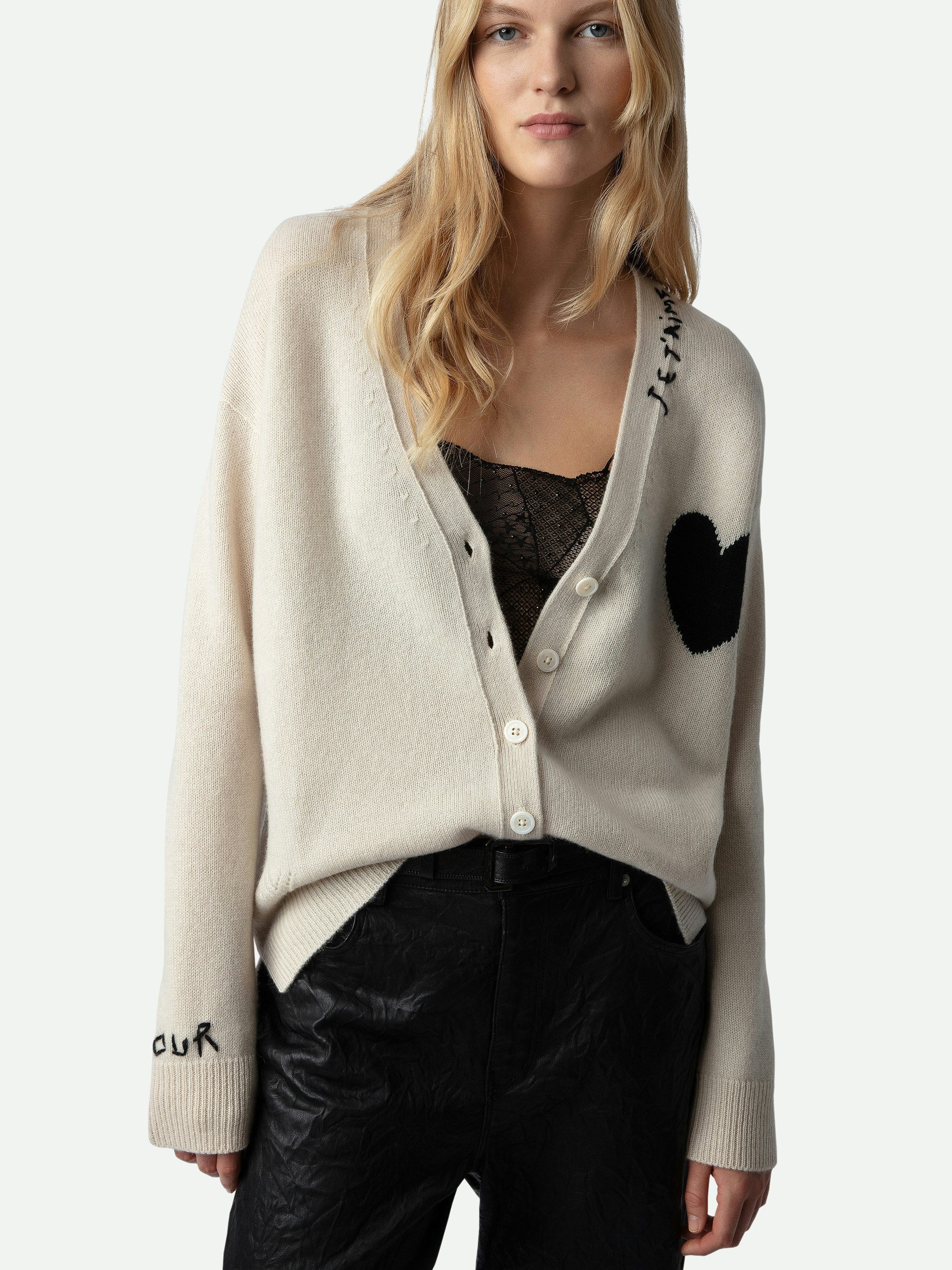 Mirka Cashmere Cardigan - A luxurious blend of softness and Parisian flair. Crafted from 100% premium cashmere, this ecru-hued cardigan offers a cozy yet lightweight feel, perfect for layering across seasons. The design features a contrasting black heart motif on the chest, complemented by intarsia jacquard slogans "Je t'aime" and "Amour" that add a touch of romantic charm.​