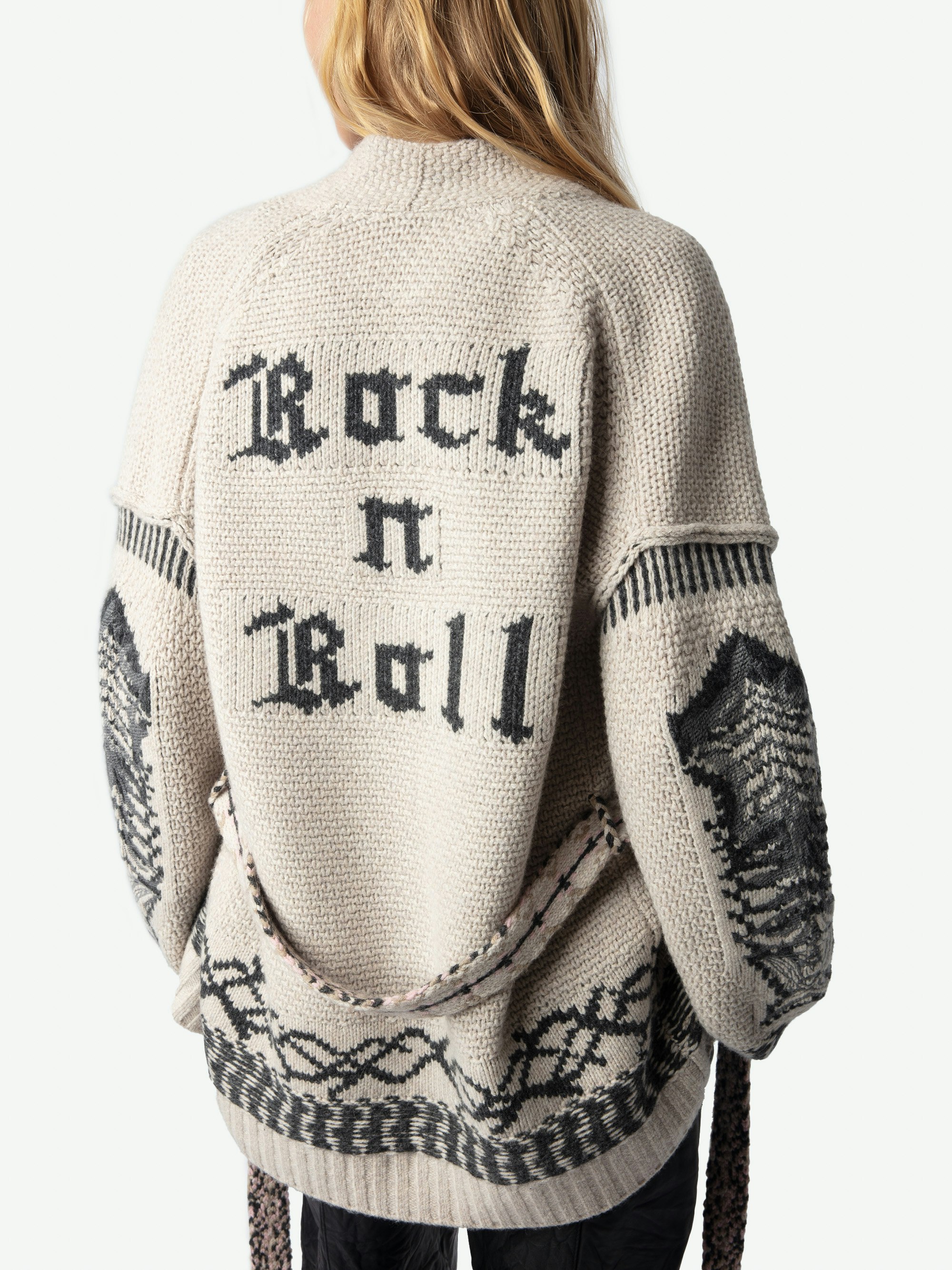 Aspen Belted Sweater Coat - A harmonious blend of bohemian flair and contemporary edge. Crafted from a luxurious mix of merino wool and cashmere, this beige cardigan features contrasting patterns that evoke a free-spirited aesthetic. The removable belt cinches the waist, allowing for a personalized fit that flatters any silhouette. More than just a piece of clothing; it's a statement of effortless chic. Embrace the brand's signature rock 'n' roll-inspired style with this versatile addition to your wardrobe.