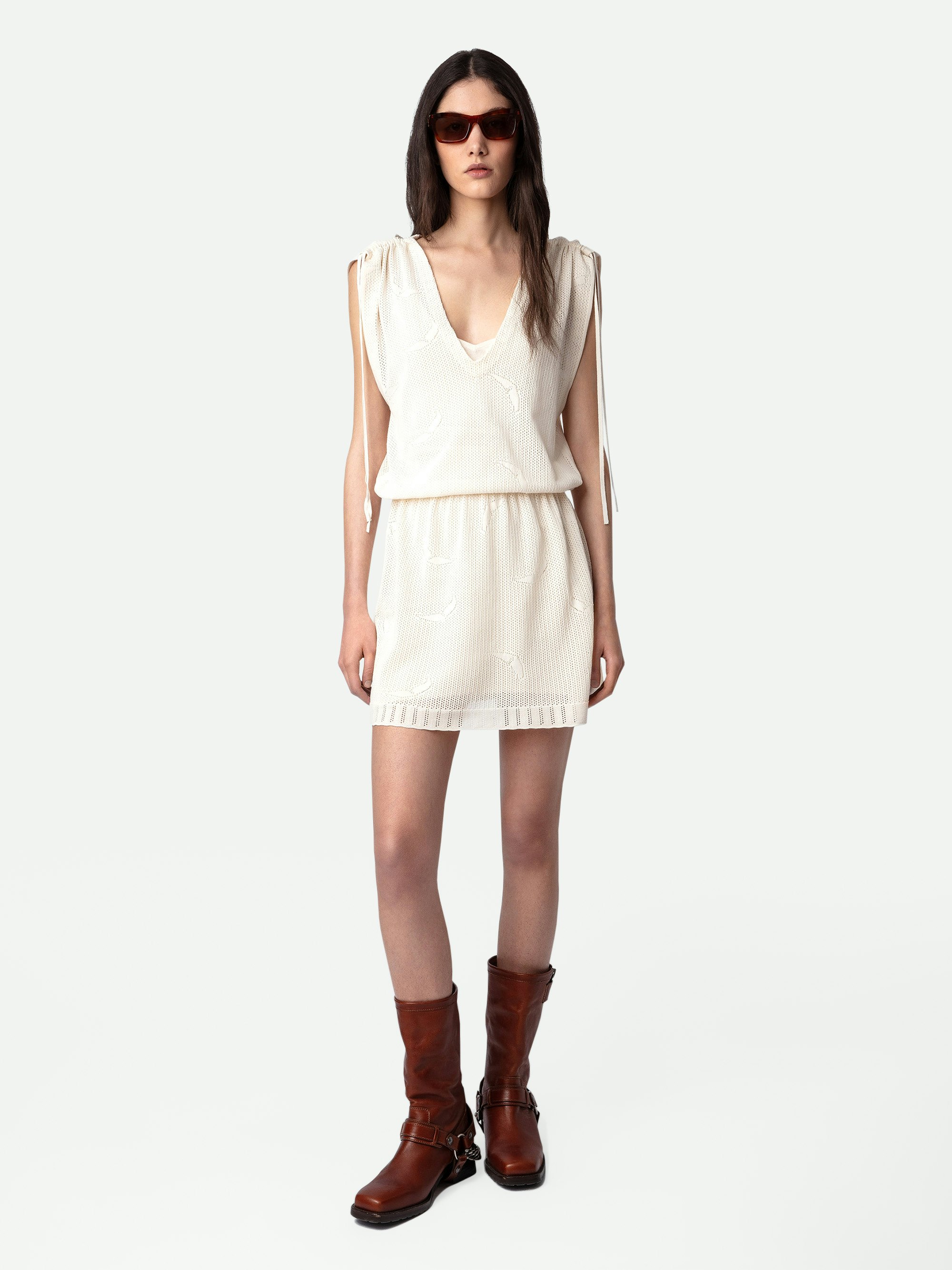 Kleid Alanis - Kurzes Kleid aus ecrufarbener Baumwollspitze mit elastischer Taille und kurzen Ärmeln mit Bändern.