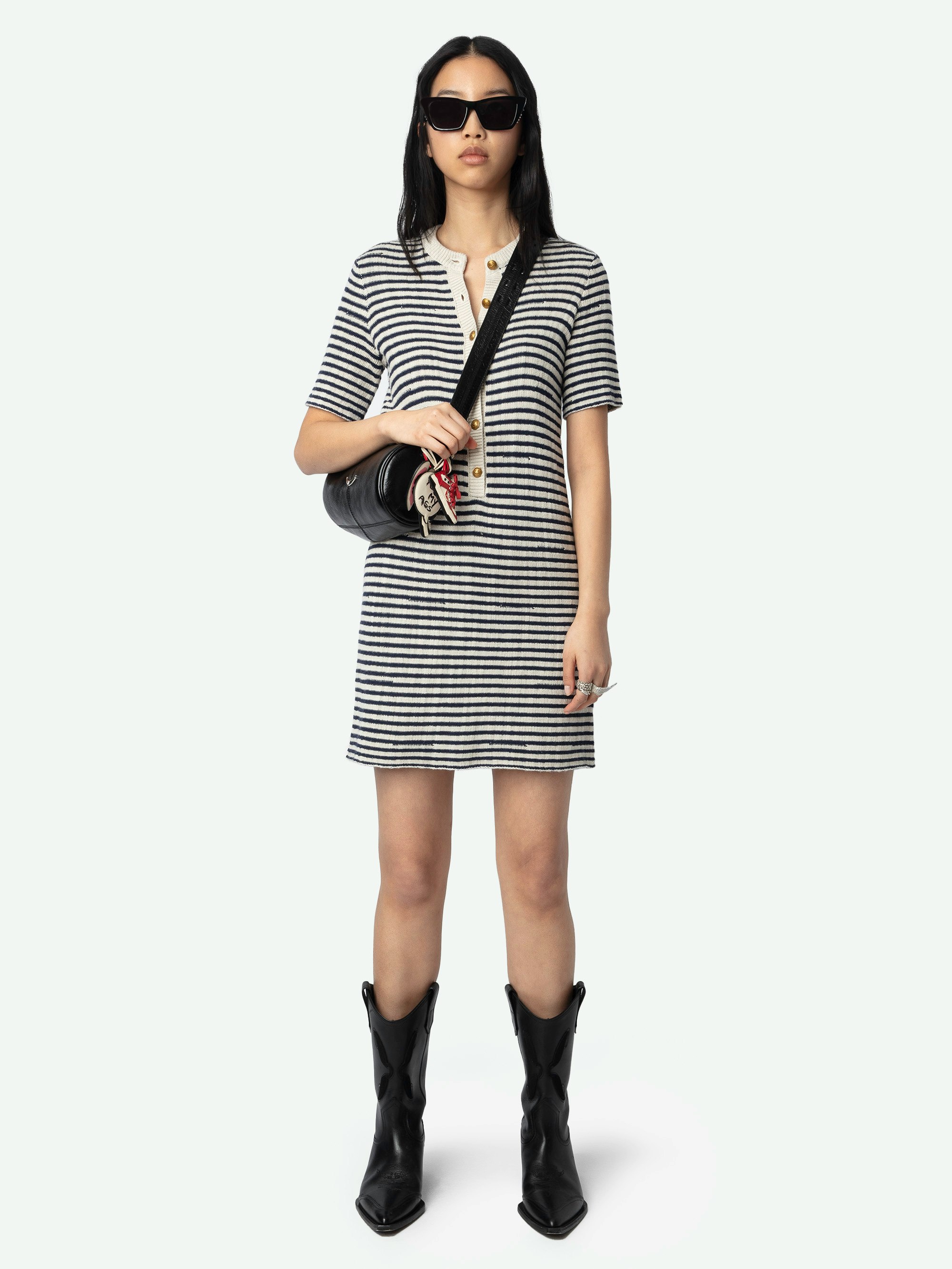 Tahoe Dress - A chic fusion of nautical inspiration and contemporary style. This short-sleeved sailor dress features a refined buttoned collar, exuding a timeless elegance that seamlessly aligns with the brand's modern aesthetic. Crafted in a deep encre striped print, the Tahoe Dress is perfect for the fashion-forward woman seeking a versatile piece that transitions effortlessly from day to night.