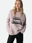 Malta Mon Amour Sweater - Wrap yourself in comfort with the women’s “Mon Amour” sweater, crafted from soft primrose pink merino wool. Featuring an intarsia jacquard “Mon Amour” slogan and delicate pointelle ZV signature, this sweater adds a touch of elegance to your wardrobe. Its thumbholes, ribbed trim, and classic round neckline offer both style and practicality. A cozy yet chic essential, this mon amour sweater is perfect for any occasion.