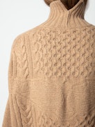 Alma Sweater - Long, loose-fitting sweater in brown knit with funnel neck, twists, embroidery on the sides and wing motifs on the back.