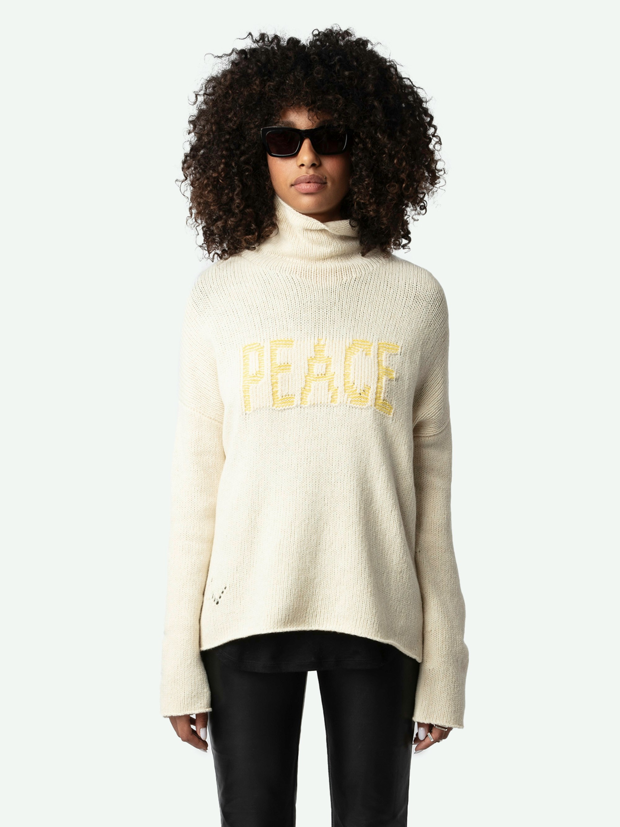 Almy Sweater - Long, loose-fitting, light yellow merino wool sweater with funnel neck and "Peace" message in contrasting tweed.