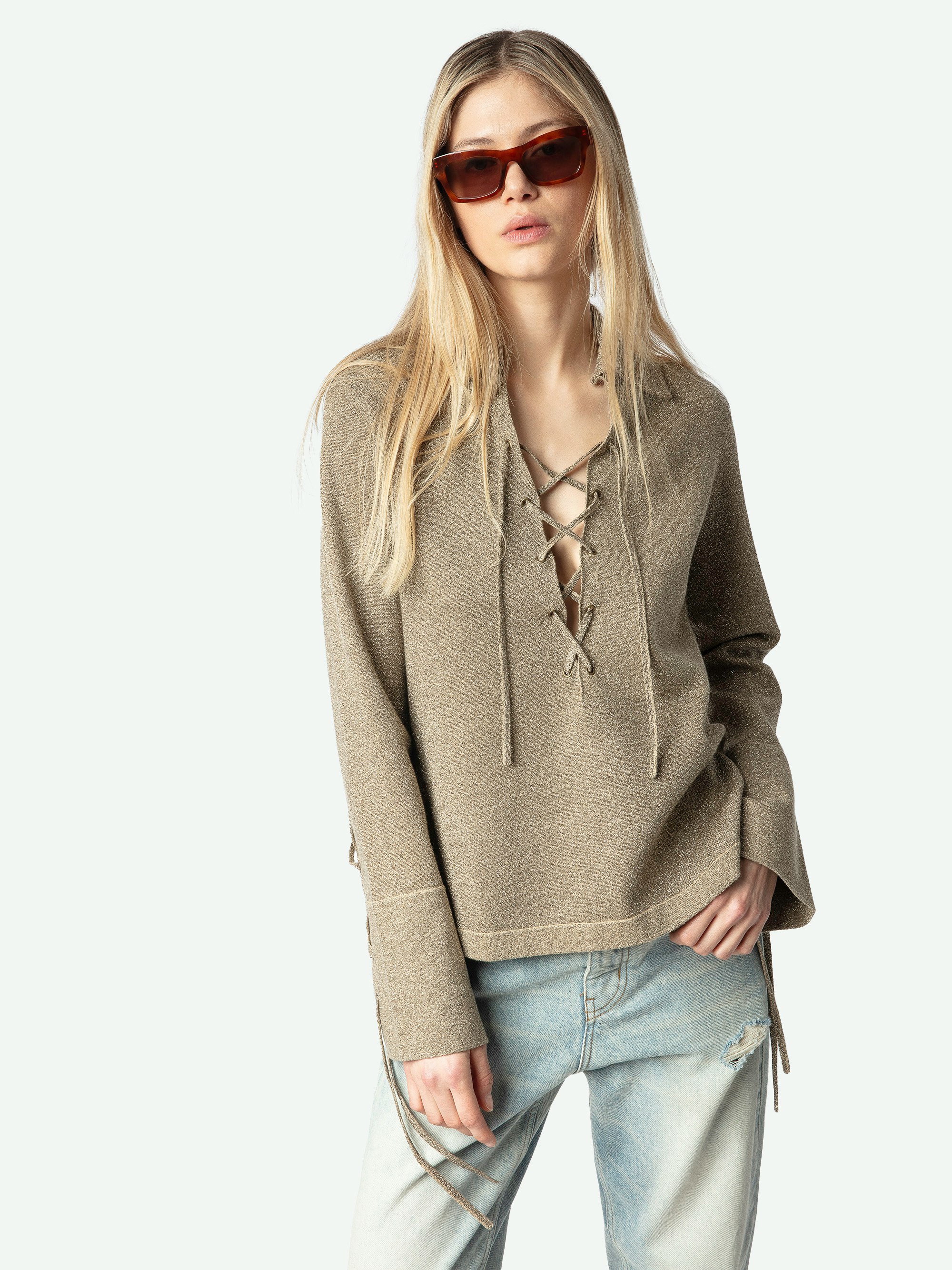 Listy Lurex Sweater - The Listy elevates everyday knitwear with a flash of quiet shine. Spun with fine metallic thread, this lurex sweater glows in soft gold while keeping a feather-light feel. A shirt-style collar is edged with metal eyelets and finished with long ties you can knot or let hang loose for a subtle rock nod. Long sleeves and buttoned cuffs add structure, and the relaxed shape slips easily over silk, denim, or leather. The result is a lurex sweater that moves from coffee to last-call sets without missing a beat.