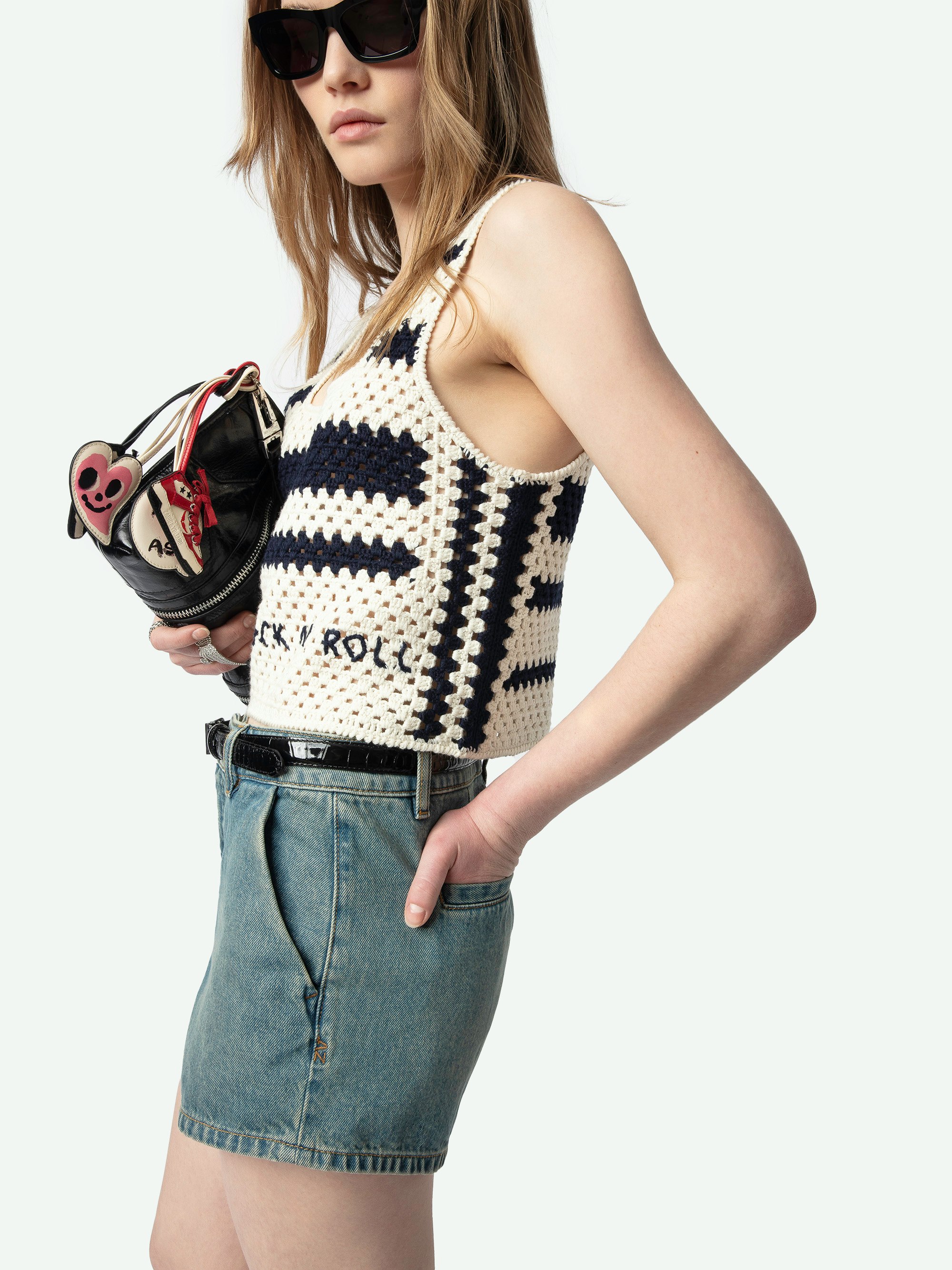 Dillie Crochet Knit Tank Top - A harmonious blend of bohemian charm and contemporary edge. This sleeveless crochet top, crafted from 100% cotton, features intricate embroidery that adds a touch of artisanal flair. The square neckline and wide straps provide a flattering silhouette, while the relaxed fit ensures comfort and versatility. Embrace effortless style with this unique addition to your wardrobe.