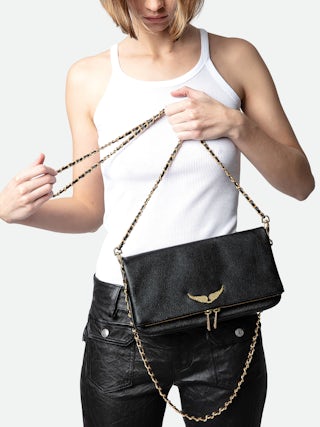 Rock Clutch - Grained leather clutch with double leather and metal chains and rhinestone-adorned wings.