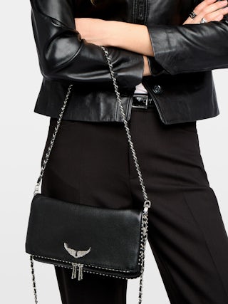 Rock Studs Pochette - Iconic rock clutch in black grained leather with studs.