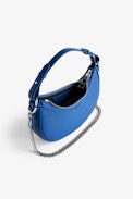 Moonrock Bag - Women’s half-moon bag in blue grained leather with a short handle, shoulder strap, chain and signature wings.