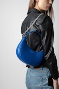 Moonrock Bag - Women’s half-moon bag in blue grained leather with a short handle, shoulder strap, chain and signature wings.