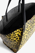 Le Borderline Leopard Bag - Women’s reversible tote bag in yellow leopard-print patent leather with handle and metal wings.