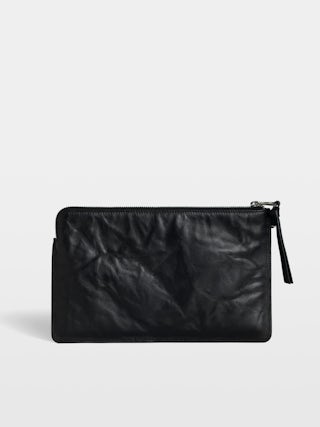 Angel Pochette - Grained leather clutch adorned with an embossed wing signature.