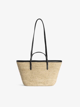 Mini Wings Basket Bag - Small raffia basket with leather handles, adorned with wings.