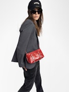 Sunny Mood Vintage Patent Tasche - Kleine Tasche aus Lackleder im Vintage-Stil mit verstellbarem Schulterriemen und Flügel-Signatur.
