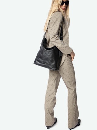 Jane Hobo Bag - Laid-back elegance with a rock ‘n’ roll twist. The Jane hobo bag blends soft, slouchy leather with signature edgy details, featuring the iconic debossed wings on the front for a bold statement. Designed for versatility, its adjustable strap lets you wear it your way—crossbody, shoulder, or effortlessly in hand. An everyday essential, always with an attitude.