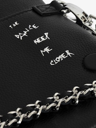 Rock Clutch - Graffiti-printed grained leather clutch with double chain in leather and metal, and wings adorned with rhinestones.