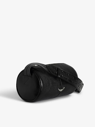 Le Doudou Black Barrel Bag - Timeless rebellion meets a Parisian edge in this black barrel bag crafted from vintage-effect patent leather. Sleek yet distinctive, it redefines everyday luxury with Zadig&Voltaire’s signature wings and modern proportions. Designed with an adjustable strap and versatile zip closure, this black barrel bag transitions seamlessly from day to night, making it the perfect piece for women who embrace both sophistication and attitude.