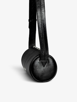 Le Doudou Black Barrel Bag - Timeless rebellion meets a Parisian edge in this black barrel bag crafted from vintage-effect patent leather. Sleek yet distinctive, it redefines everyday luxury with Zadig&Voltaire’s signature wings and modern proportions. Designed with an adjustable strap and versatile zip closure, this black barrel bag transitions seamlessly from day to night, making it the perfect piece for women who embrace both sophistication and attitude.