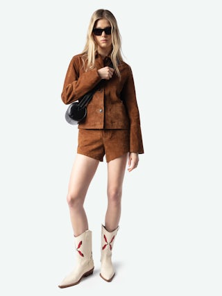 Le Doudou Black Barrel Bag - Timeless rebellion meets a Parisian edge in this black barrel bag crafted from vintage-effect patent leather. Sleek yet distinctive, it redefines everyday luxury with Zadig&Voltaire’s signature wings and modern proportions. Designed with an adjustable strap and versatile zip closure, this black barrel bag transitions seamlessly from day to night, making it the perfect piece for women who embrace both sophistication and attitude.