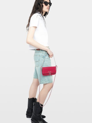 Rock Nano Clutch - Grained leather pochette with double leather and metal chains and rhinestone-adorned wings.