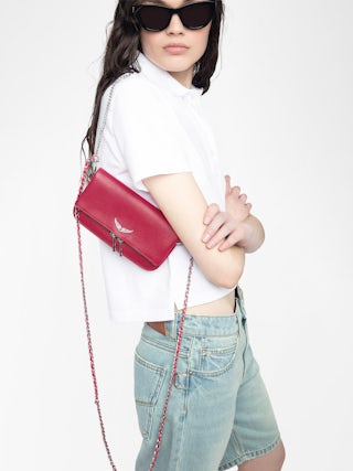 Rock Nano Clutch - Grained leather pochette with double leather and metal chains and rhinestone-adorned wings.