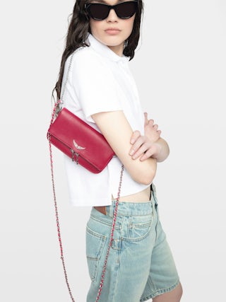 Rock Nano Clutch - Grained leather pochette with double leather and metal chains and rhinestone-adorned wings.