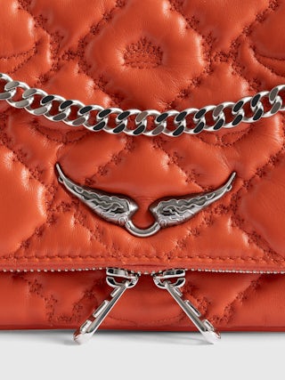 Rock II Quilted Monogram Clutch - Clutch in smooth quilted leather with sliding metal chain and signature wings.