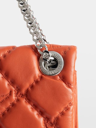 Rock II Quilted Monogram Clutch - Clutch in smooth quilted leather with sliding metal chain and signature wings.