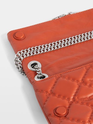 Rock II Quilted Monogram Clutch - Clutch in smooth quilted leather with sliding metal chain and signature wings.