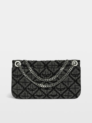 Rock II Monogram Clutch - Clutch in denim with sliding metal chain and signature wings.