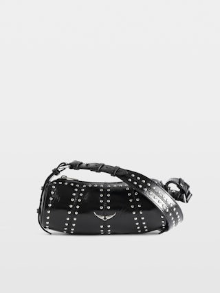 Bolso Le Roudoudou Studs - Bolso de charol de efecto vintage con tachuelas, bandolera ajustable y alas emblemáticas.