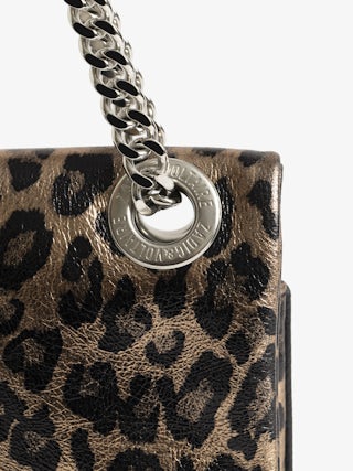 Rock II Metal Leopard Clutch - Metallic leather clutch with leopard effect featuring sliding metal chain and signature wings.