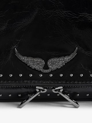 Rock Vintage Patent Studs Clutch - Clutch in patent leather with vintage effect featuring double leather and metal chains adorned with studs and rhinestone wings.