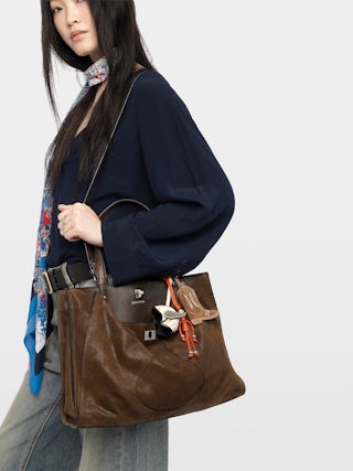 Jack Bag - Suede leather bag with signature clasp, featuring two compartments, one handle and adjustable strap.