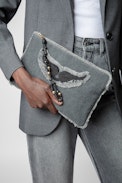 Uma Clutch - Women's black cotton clutch bag with fringing, wings patch and a beaded strap