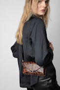 Borderline Leopard Clutch - Women’s brown patent leather leopard-print clutch with shoulder strap with wings charm.
