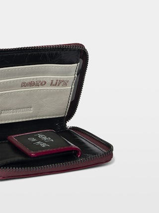 Sunny Mini Punk Geldbörse - Geldbörse aus Lackleder mit Vintage-inspiriertem Effekt, Medaillon und Flügel-Signaturen.