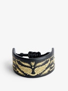 Pulsera Lenny - Brazalete negro de cuero anudable con alas doradas.